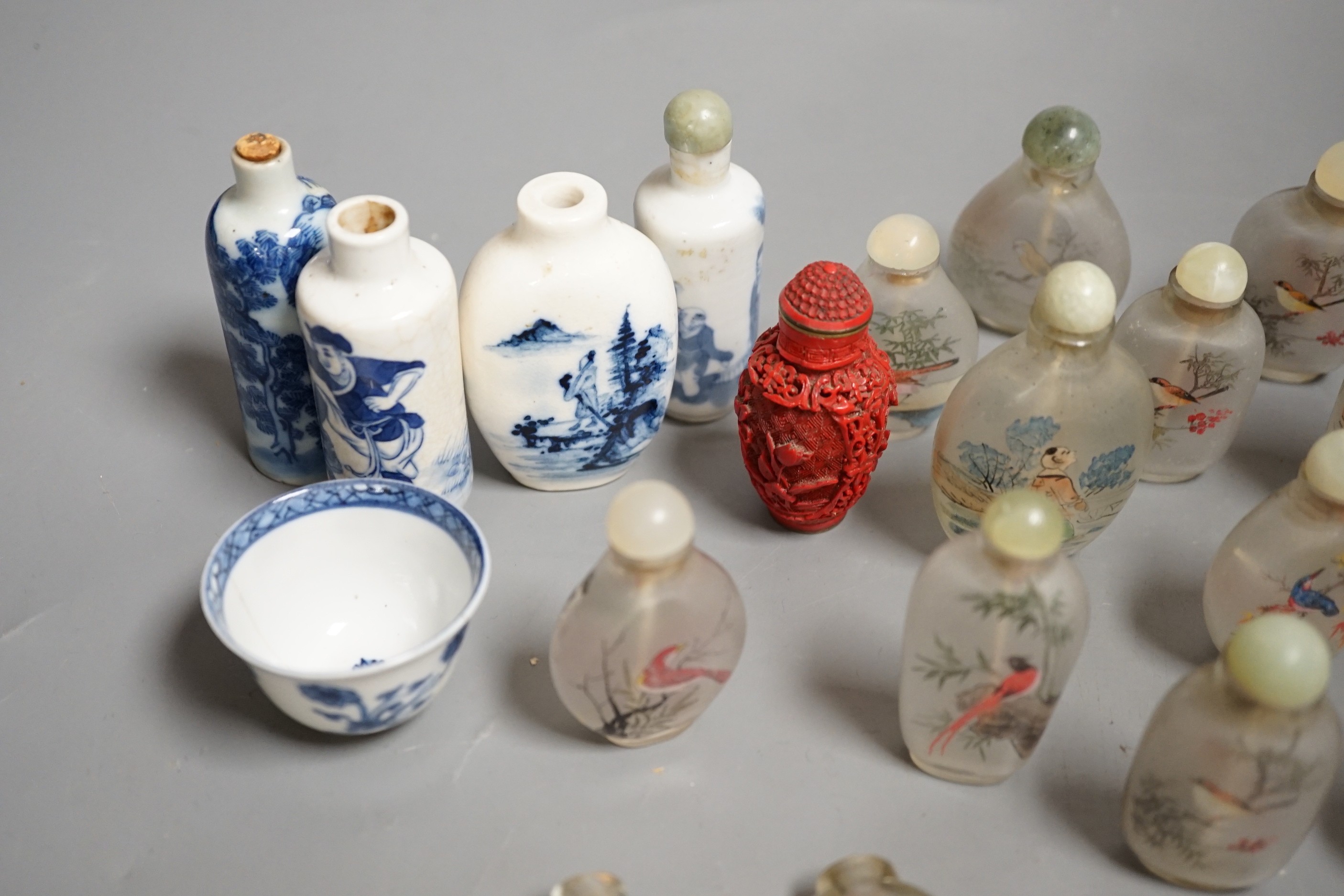 A collection of 20th century Chinese export reverse painted snuff bottles with associated blue and white porcelain examples, some 19th century